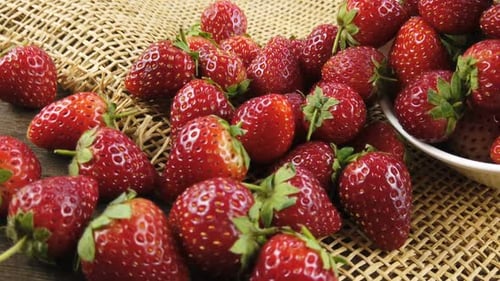 Ripe Strawberries on Burlap with Bowl
