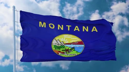 Montana State Flag Waving Against Blue Sky