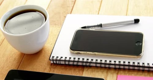 Desk with Office Supplies, Phone, and Coffee