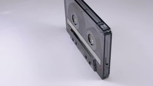 Vintage Audio Cassette Tape Rotating on White Surface
