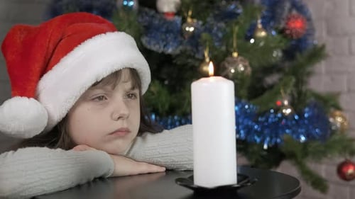 Alone Child with Candle at Christmas Night