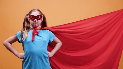 Girl Dressed as Superhero Poses with Hands on Hips