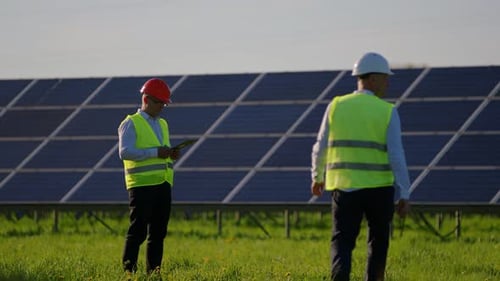 Engineers at Solar Panel Installation Site Shaking Hands