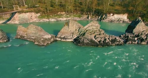 Low Altitude Flight Over Fresh Fast Mountain River with Rocks at Sunny Summer Morning