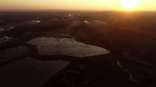 Aerial View of a Lake at Golden Sunrise