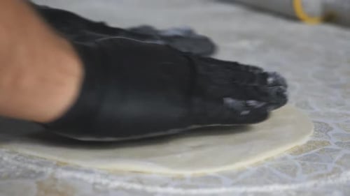 Preparing Fresh Pizza Dough with Gloves