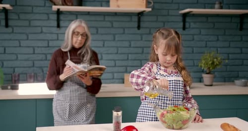 Child and Grandmother Cooking Together in Kitchen