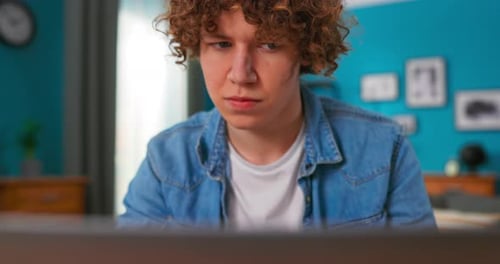 Young Adult Using Laptop At Home