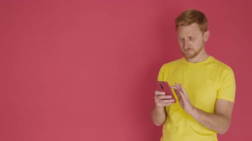 Man with Smartphone Reacts with Joy