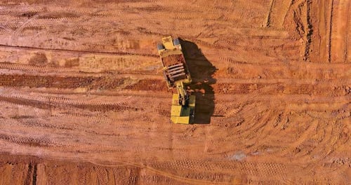 Excavator Working on Construction Site from Above