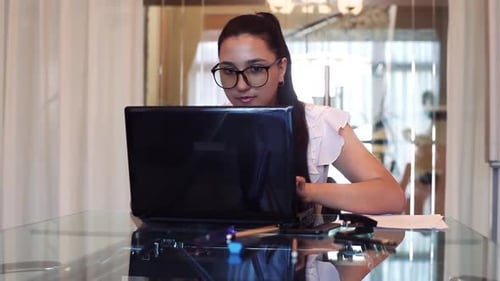 Une fille d'affaires se réjouit après avoir appris la bonne nouvelle au bureau assise à table
