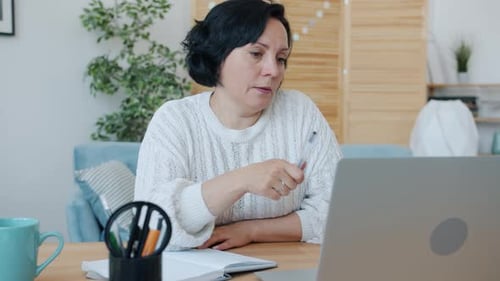 Woman Participating in Video Conference from Home