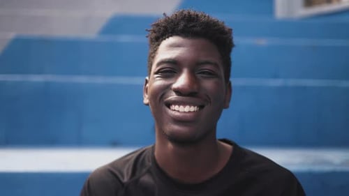 Smiling Young Man Portrait on Blue Stairs