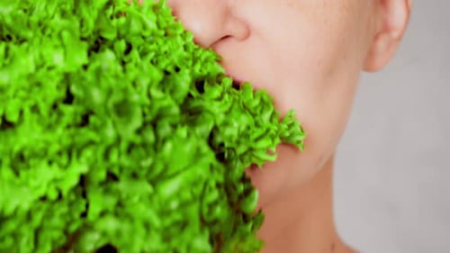 Close Up Face Young Woman Eating Leaf Vegetable
