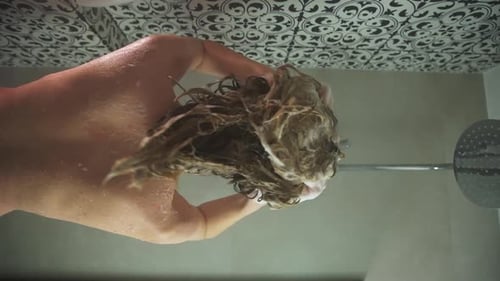 Woman Lathers Shampoo in Shower