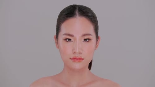 Beautiful Woman with Flawless Makeup Posing in Studio