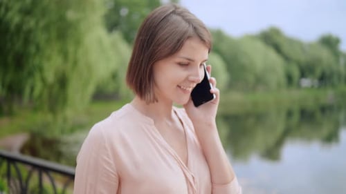 Female Going on the Street Holding Mobile