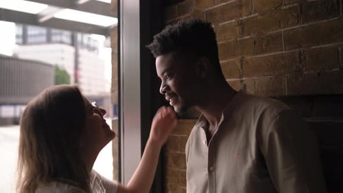 Affectionate Couple Share a Kiss in an Urban Setting