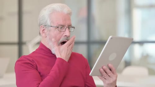 Senior Man Uses Tablet with Disappointed Reaction