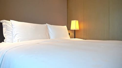 Clean Bed with White Linens and Lamps