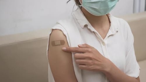 Vaccinated Person with Digital Vaccine Card on Phone