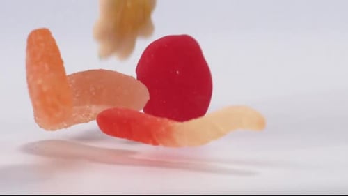 Assorted Gummy Candies Falling in Slow Motion