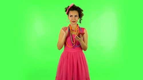 Young Smiling Woman Texting on Her Phone on Green Screen