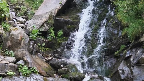Wild Mountain Waterfall. Rapid Falling Water Hitting on the Stones. Slow Motion