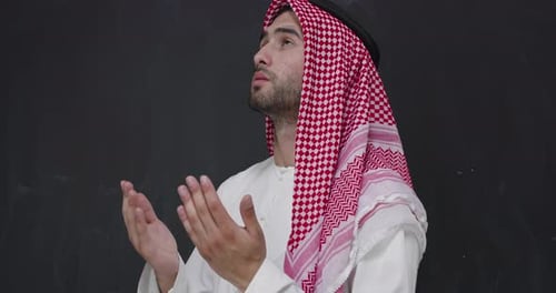 Man in Traditional Dress Praying