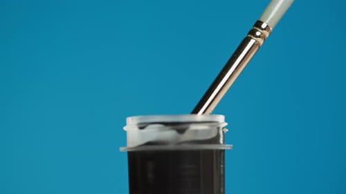 Black Paint Isolated on Blue Background