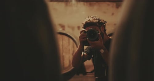 Man with Camera in Dark Room