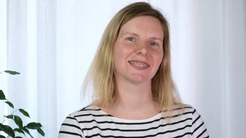 Woman with Braces Smiling in Indoor Setting