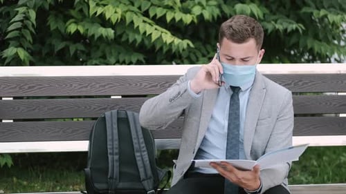 Young Adult Talking on Cell Phone in Park