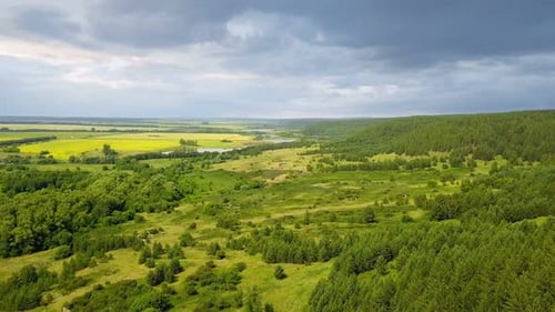 Aerial View of Rolling Green Hills and Forests