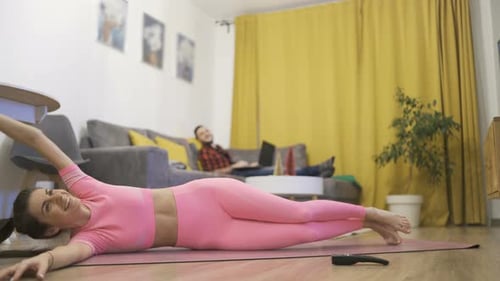 Sporty Flexible Woman Doing Stretching Exercises at Home