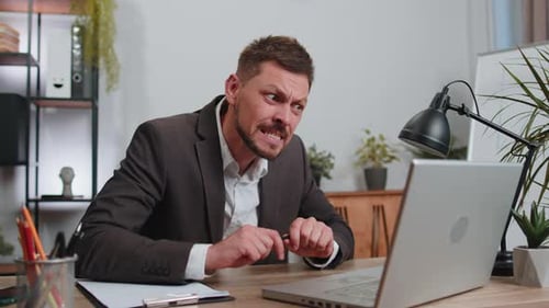 Irritated Angry Businessman Working on Laptop Analyzing Financial Graph Decrease Breaking Pencil