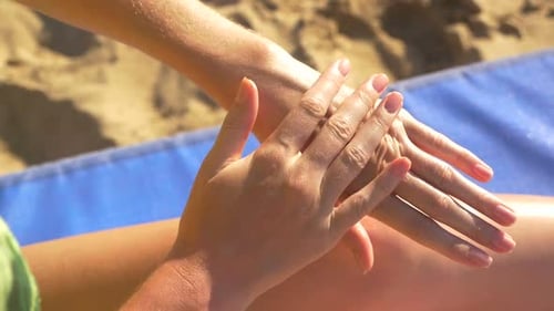 the Girl Applying Sunscreen to the Sea