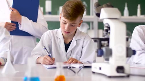 Teacher and Students Studying Chemistry at School