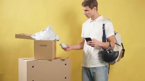 Young Smiling Delivery Man with Boxes Isolated