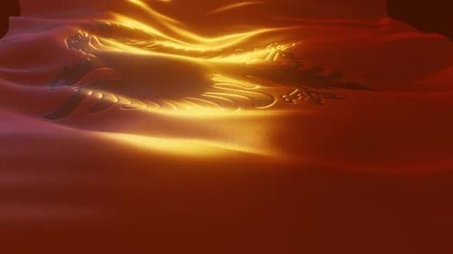 Albanian National Flag Waving with Dramatic Golden Illumination