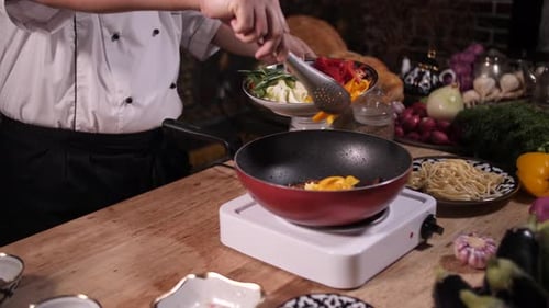 Chef Adds Vegetables to Sizzling Wok for Stir-Fry