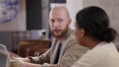 Diverse Male and Female Colleagues Speaking in Cafe