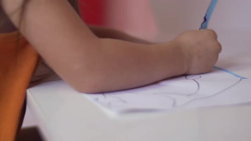 A child's hand coloring