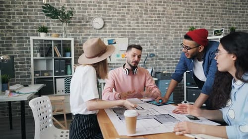 Coworkers Having Argument Discussing Business at Work Looking at Building Plan