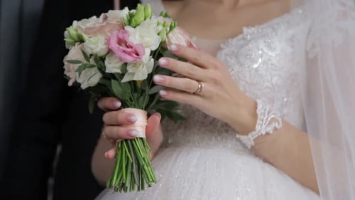Elegant Bride Holds Wedding Bouquet