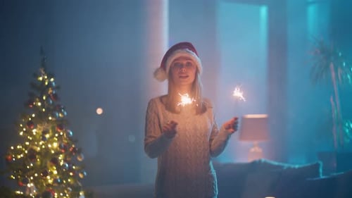 Woman Celebrates Christmas with Sparklers in Home