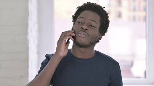 Man Talking on Smartphone Indoors
