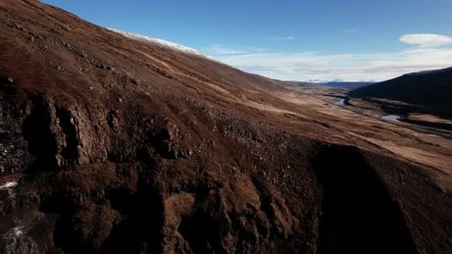 Drone Over Dramatic Icelandic Landscape of Hillsides and River
