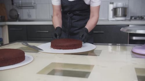 Confectionery a Woman Cuts a Chocolate Sponge Cake Into Two Parts Using a String