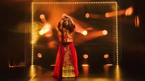 A Young Girl Dancer in Red Silk Costume and Headdress of a Chinese Princess. China Folk Dance. Shot